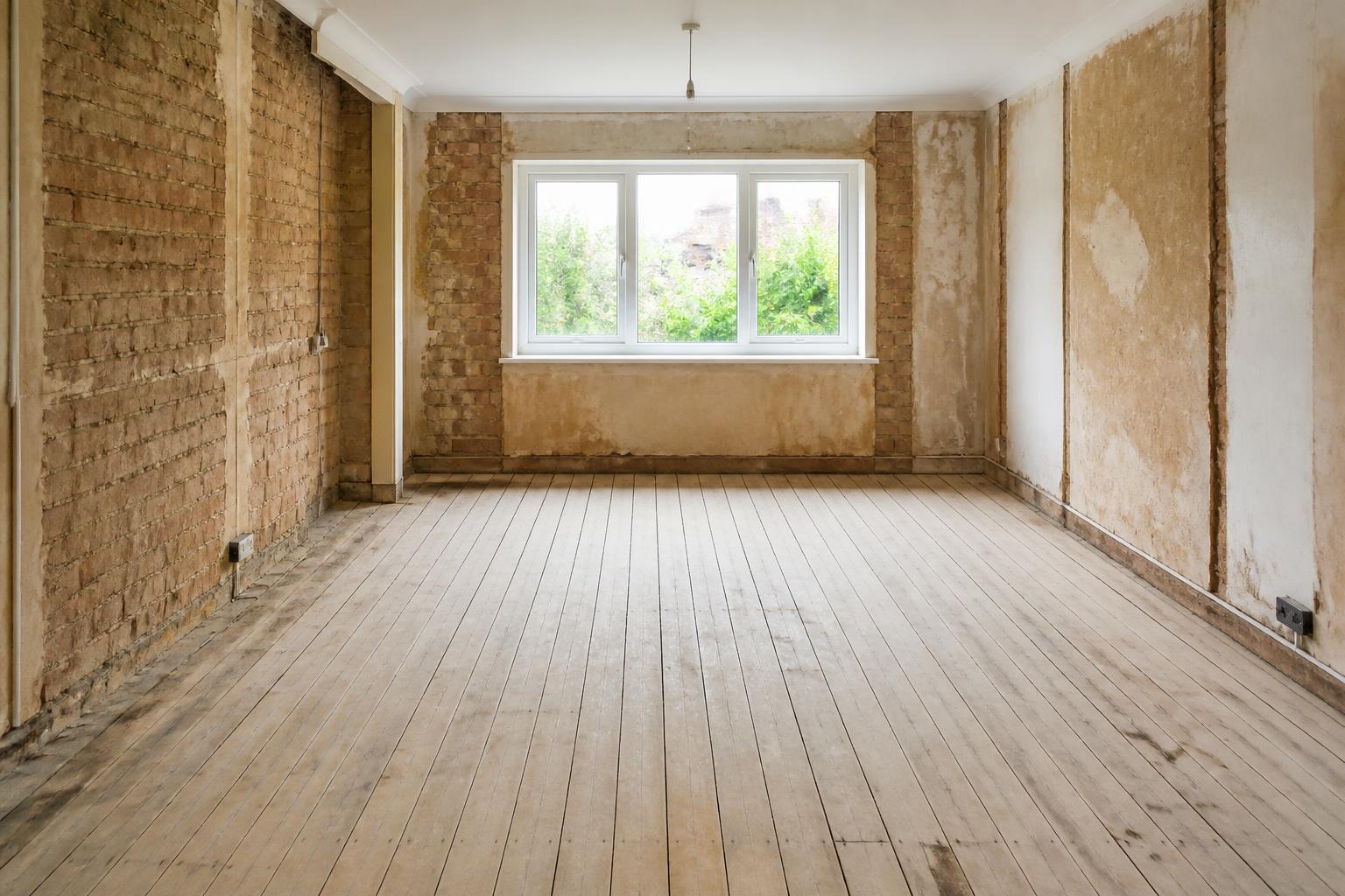 Stripped-out room swept clear of renovation waste and ready for work to continue